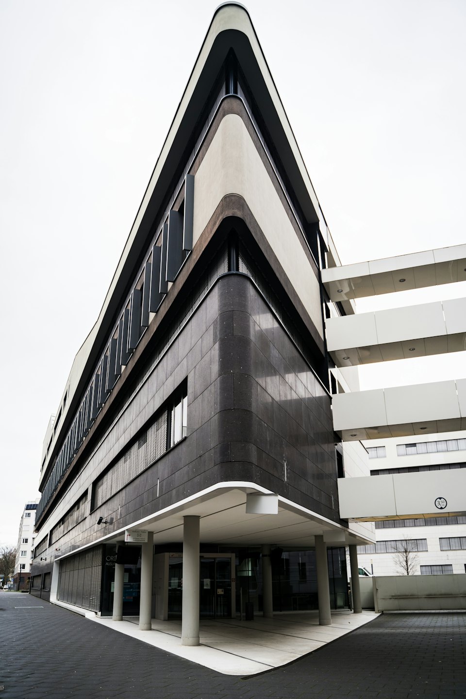 Modern office building with a pedestrian bridge connection.